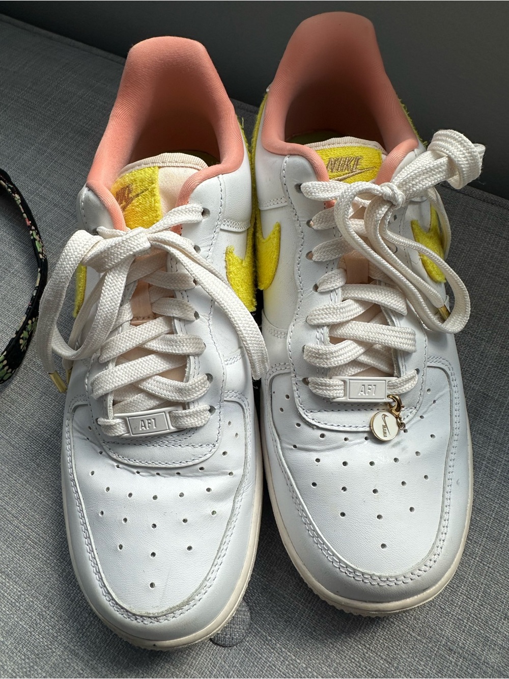 Nike White Low-Top Sneakers with Yellow Swoosh and Pink Lining